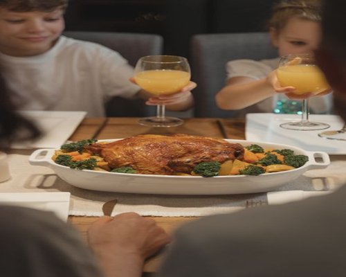 Family sitting together enjoying a healthy home cooked dinner